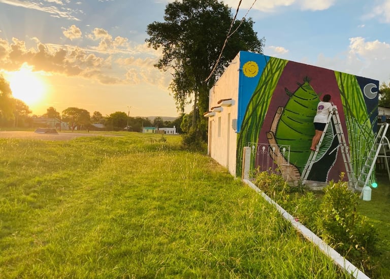 a mural of a woman in a colorful mural of a woman on a ladder