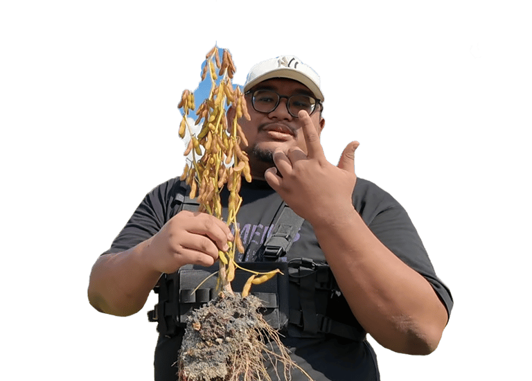 a man in a black shirt holding a plant with a plant in it