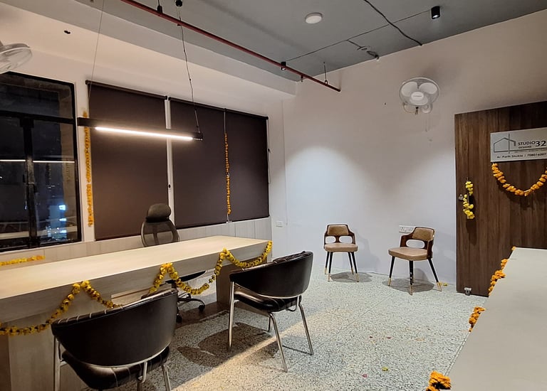 a room with a desk and chairs and a table