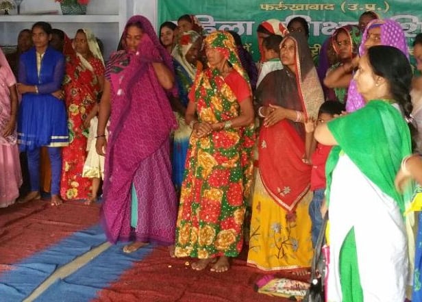 a group of women in colorful saree standing