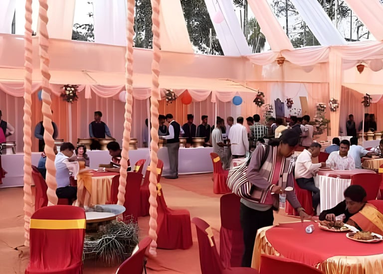 Lively event space with red and gold tablecloths, round tables, floral arrangements