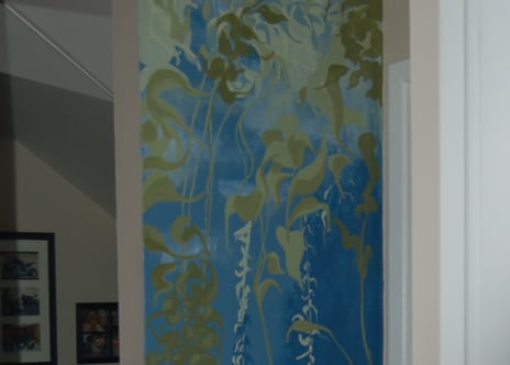 A narrow tall interior wall mural of a swaying peaceful kelp forest in greens and blues by Kathy LaFollett.