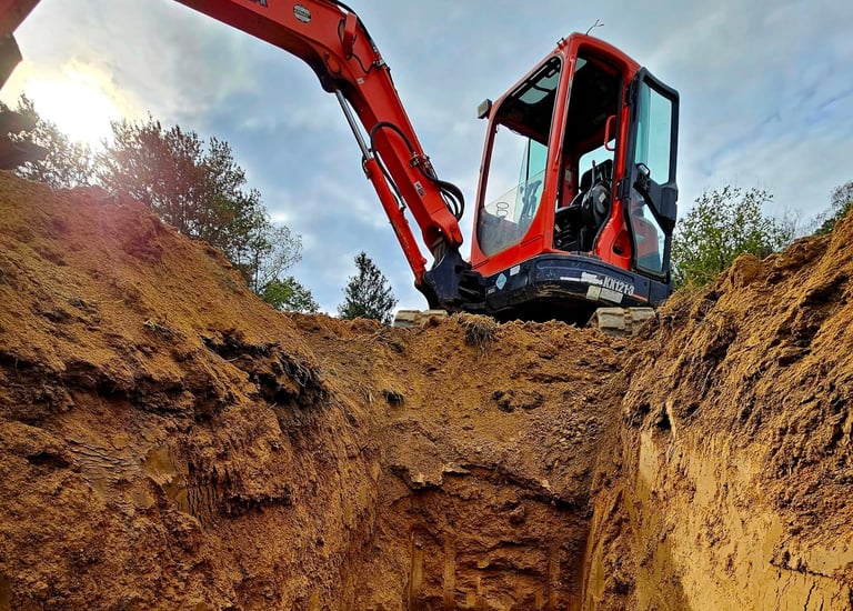 a construction worker is working on a trench