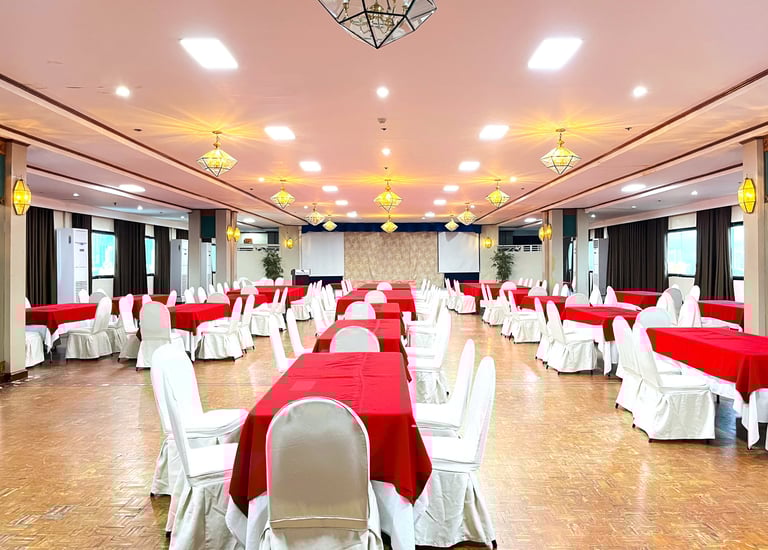 a large event function room with tables and chairs and red tablecloth