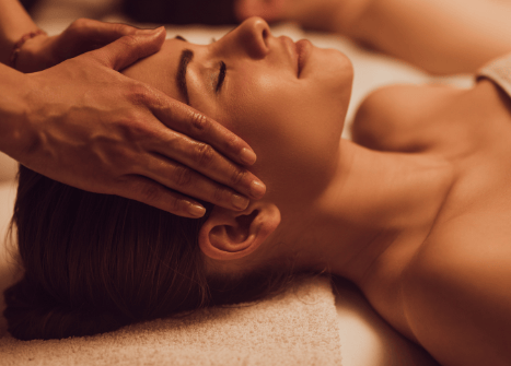 Woman enjoying soothing facial and head massage at luxury wellness spa for deep relaxation