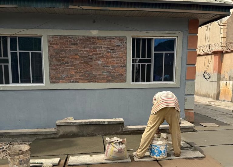 a man is painting a concrete slab in a house