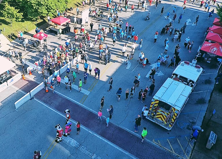 An overhead drone shot of the Start/Finish line and vendor expo at the Chick Fil A 10K in Athens, AL