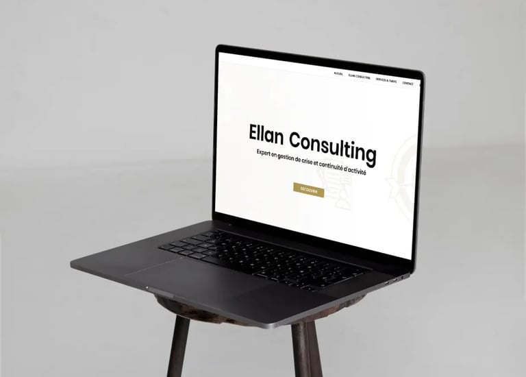 Macbook placed on a stool with the homepage of the Ellanconsulting website displayed on the screen