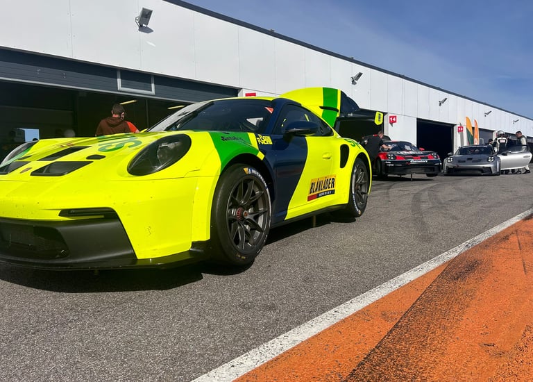 an Enlab yellow and green Porsche car with a yellow and black car in front of a building