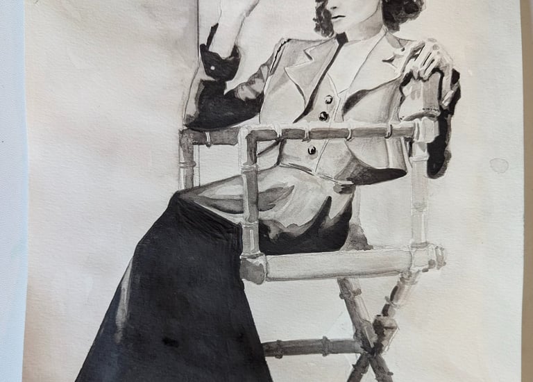 A graphite drawing of a classic 30s photo of Katherine Hepburn sitting in a director's chair rendered by Kathy LaFollett.