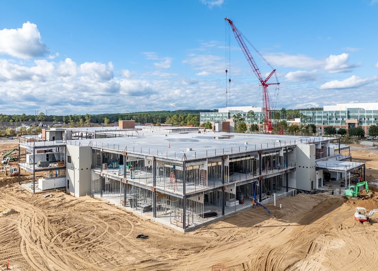 a crane is in the foreground of a construction site