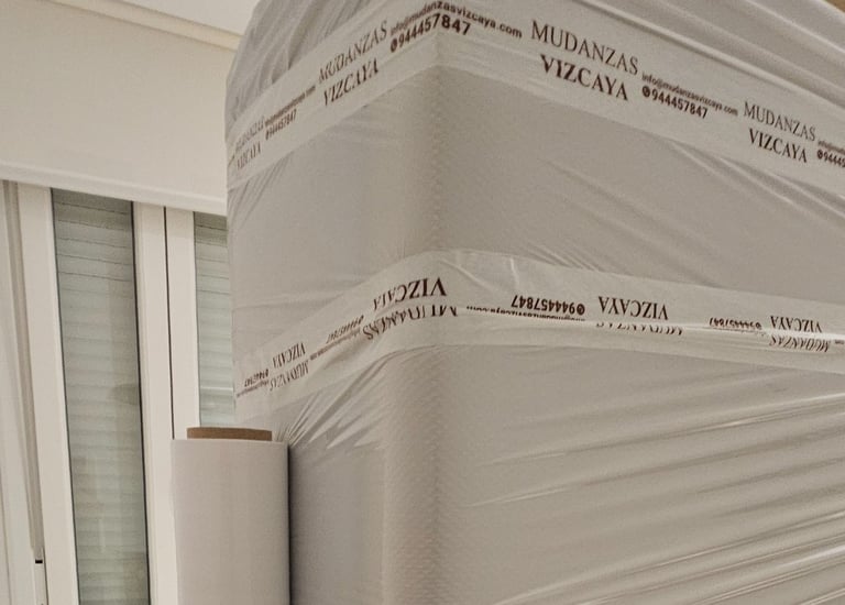 a person holding a box spring mattress on a bed