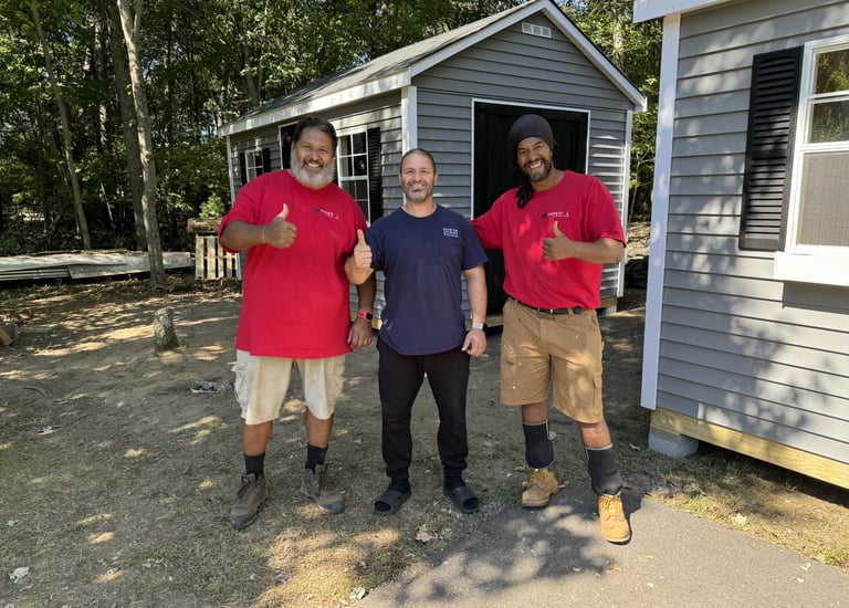 Imperial Custom Sheds crew with satisfied customer after successful on-site shed installation