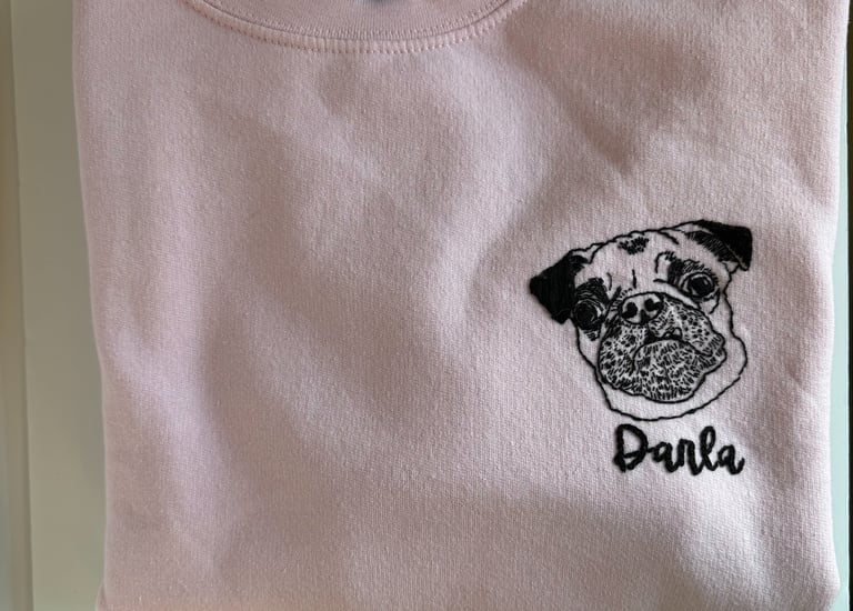 a pink shirt with a pug dog on it