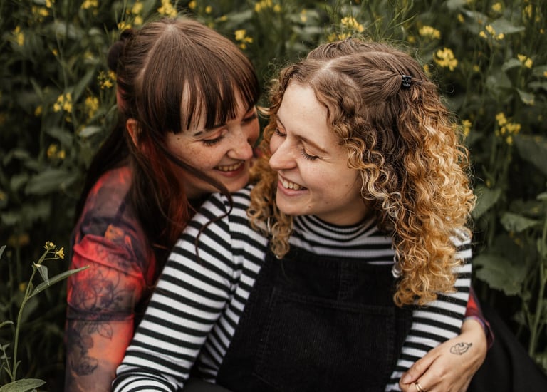 Lesbisches Paar sitzt im Gras