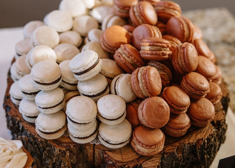 A pile of macarons shown as part of a luxury wedding dessert table