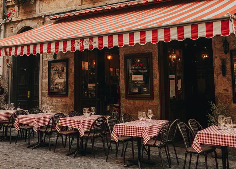 a restaurant with tables and chairs outside