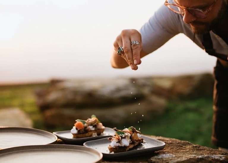 a man is sprinkling food on a table