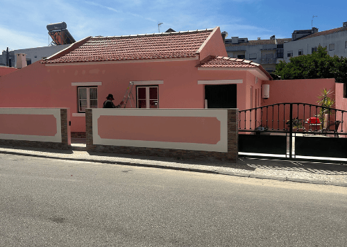 a pink house with a pink house in the background