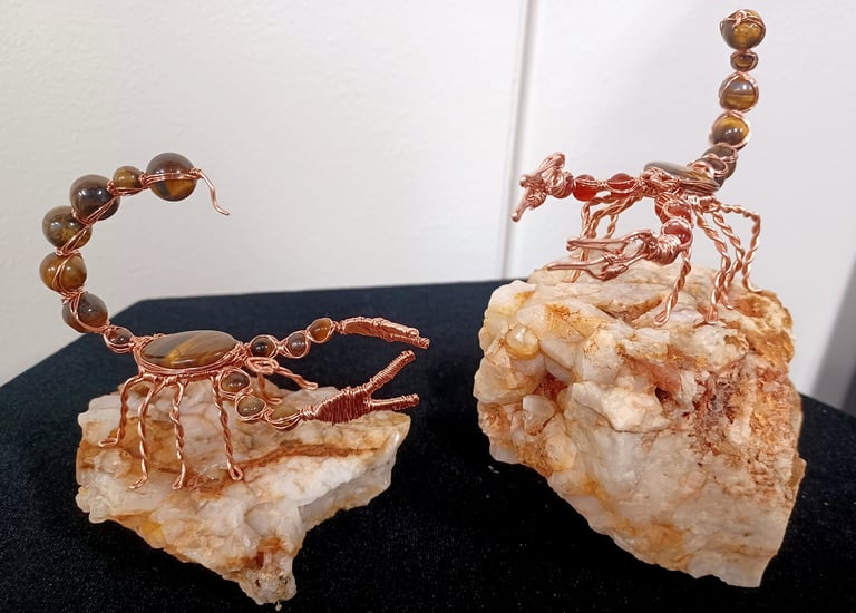 Wire wrap scorpion sculptures: copper, tiger's eye, and fire agate.