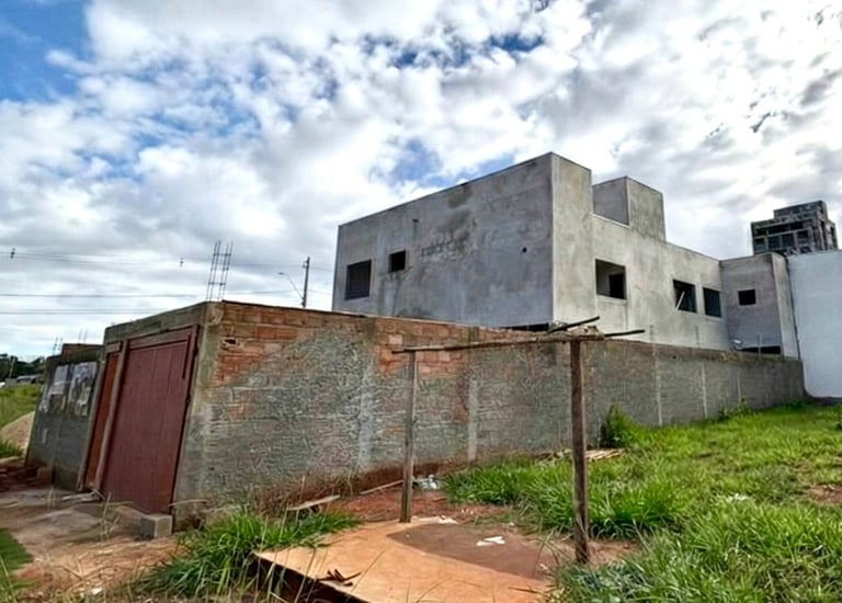 a building with a fenced in area with grass