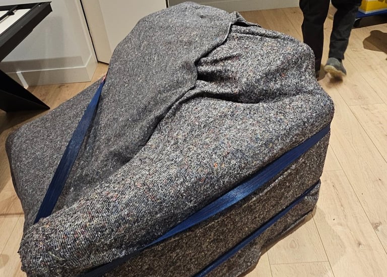 a man walking through a room with a suitcase