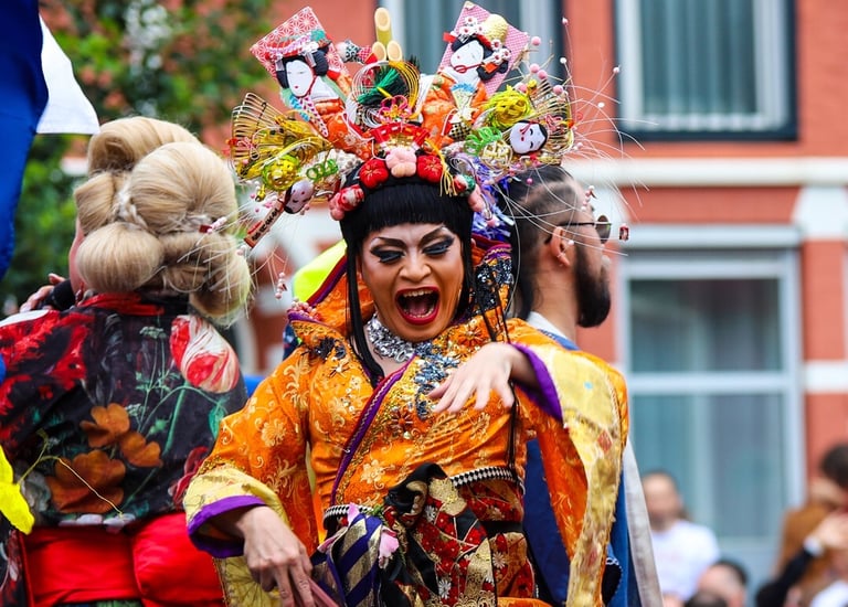 a person dressed in traditional Japanese outfit dancing in the Amsterdam Pride Parade