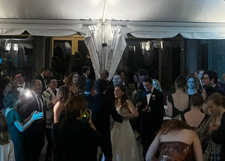 a group of people standing around a tent