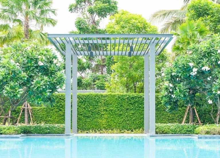 Modern pergola structure creating shade in garden by Garden Designers