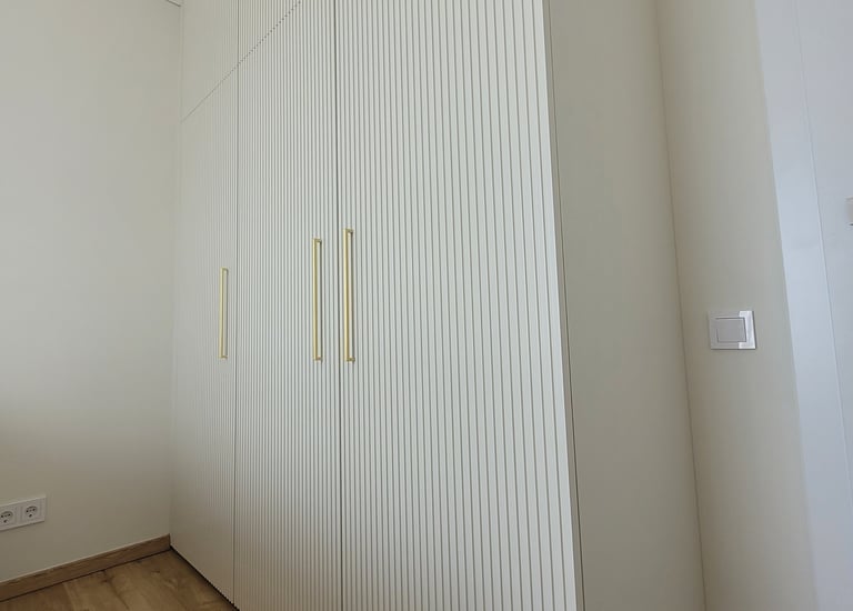 Bespoke wardrobe with fluted fronts adding texture and depth for a soft, elegant look