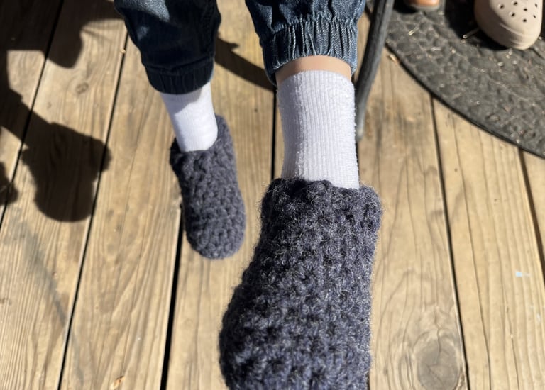 a person wearing slippers and socks with a pair of slippers