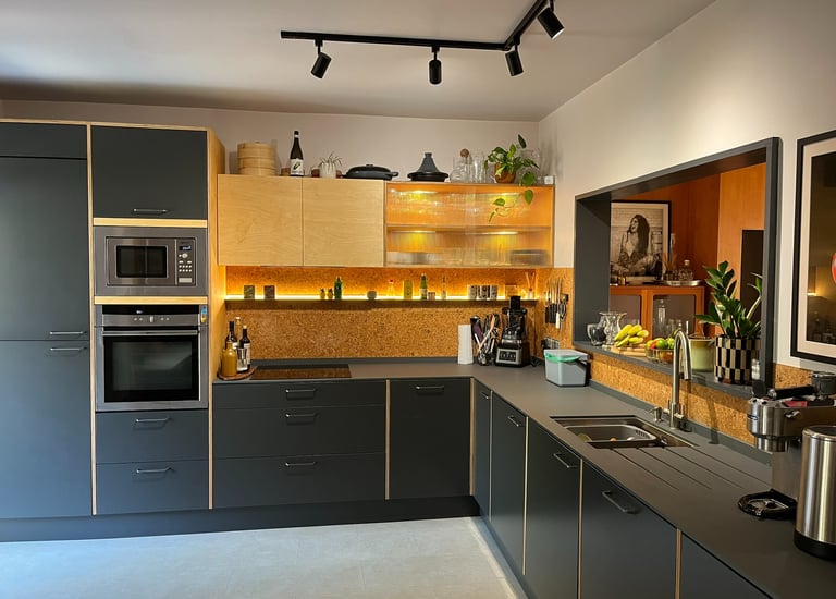 a bespoke ply kitchen with a hob and a microwave