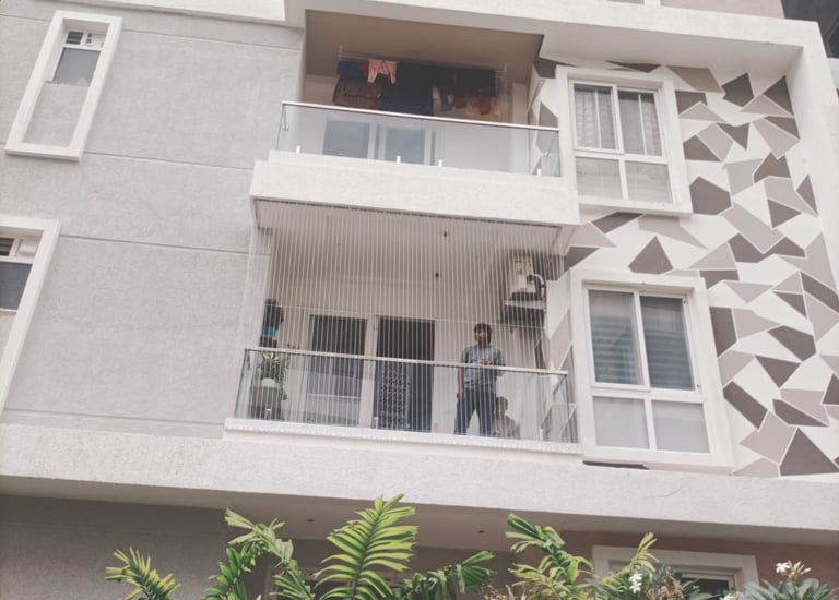 Completed installation showing clean, secure pigeon netting on a Perungudi apartment.