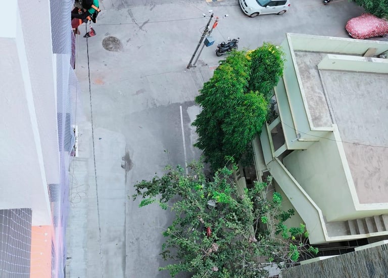 Technician from Arjillo Enterprises installing a duct area net in Whitefield, Bangalore.