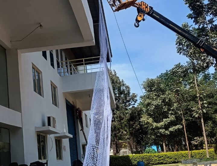 Close-up of tightly woven pigeon netting protecting warehouse vents