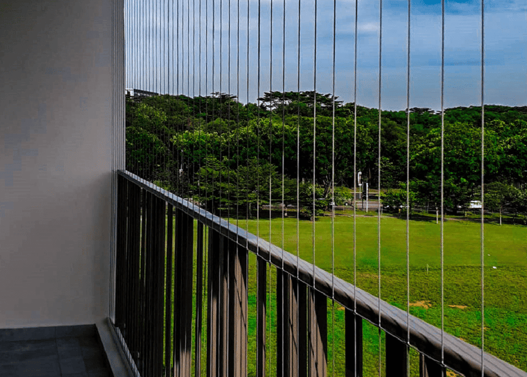 Close-up of a sleek invisible grill installed on a T Nagar balcony, blending seamlessly with the sur