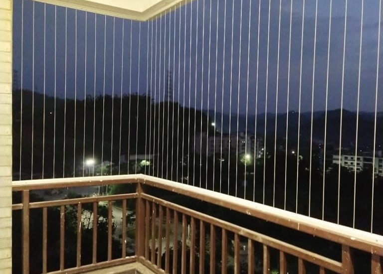 Side angle showing the minimal frame of an invisible grill on a residential window.