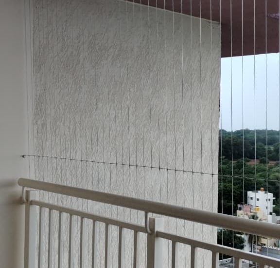 Close-up of a sleek invisible grill seamlessly fitted on a Royapettah balcony.