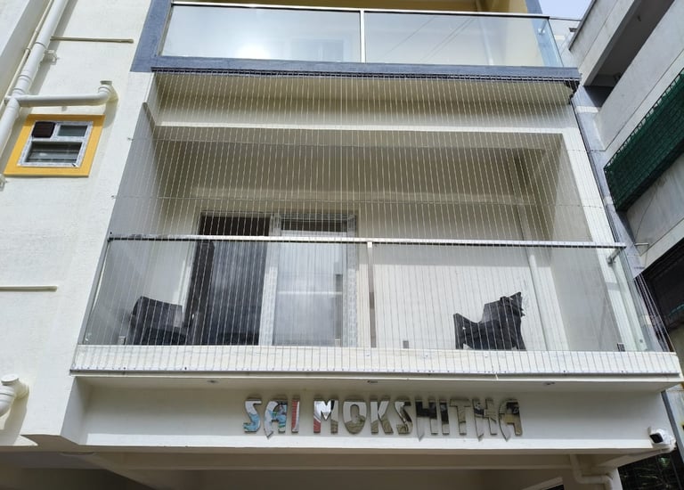 Close-up of a sleek invisible grill installed on a T Nagar balcony, blending seamlessly with the sur
