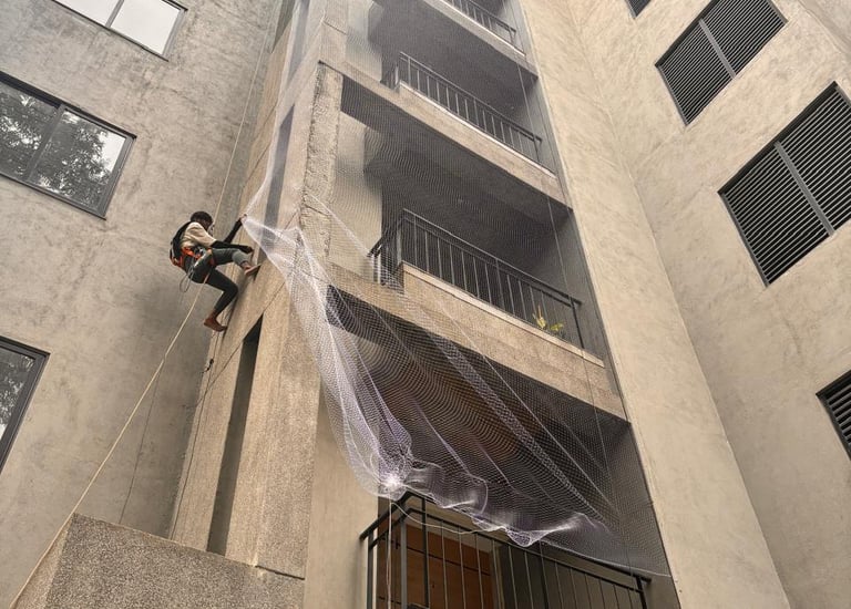 Close-up of a freshly installed balcony safety net on a high-rise apartment in Mumbai.