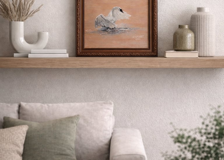Framed swan oil painting displayed on a wooden floating shelf above a neutral living room sofa.