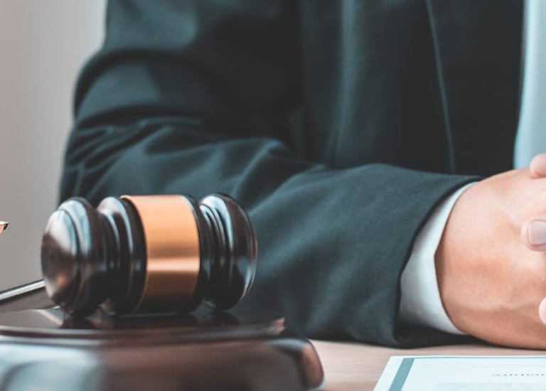 a judge's hand holding a gavel and a gavel