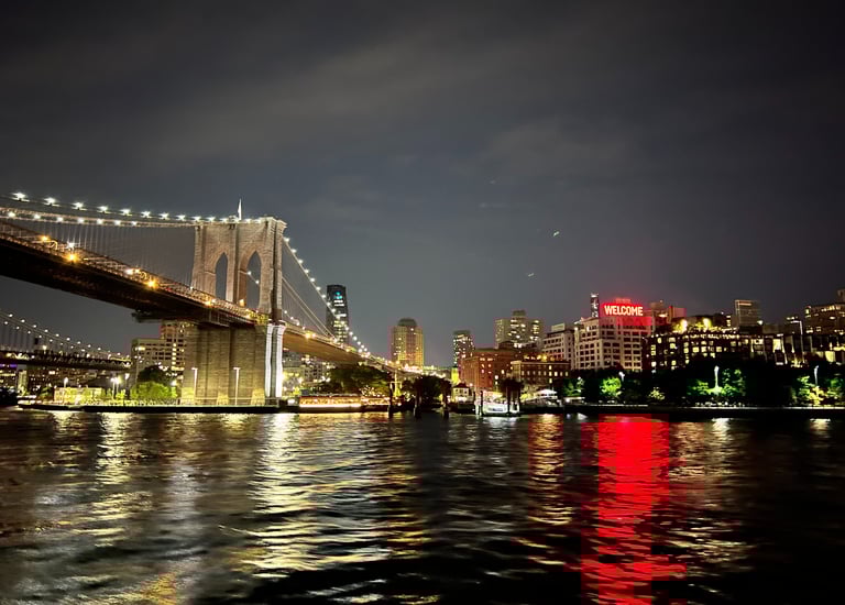 brooklyn bridge at night welcoming visitors into Brooklyn ny