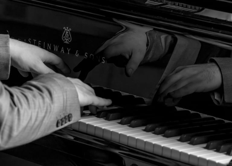 Stathis Chomatsas playing piano in a concert hall during a photoshoot