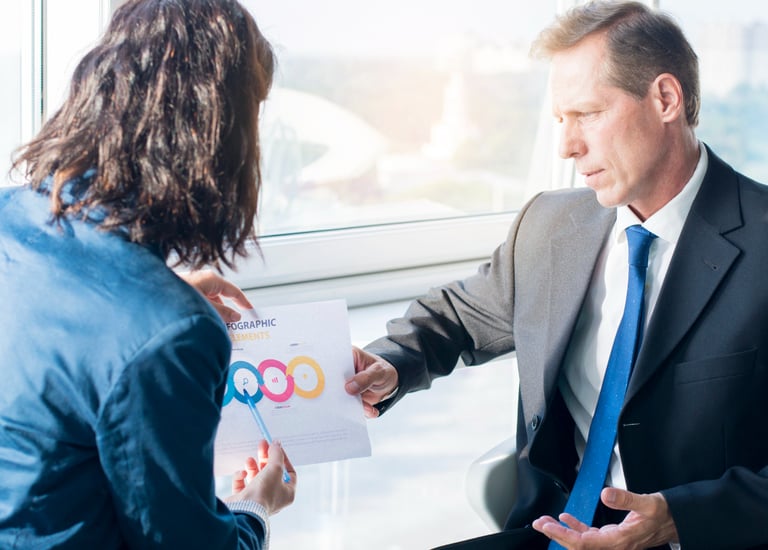 Web designer discussing a custom website solution with a client, showcasing EZ Web Builds' client-ce