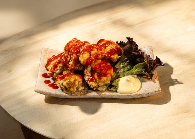 Crispy Japanese chicken karaage drizzled with spicy red sauce, served with fresh lettuce and mayo.