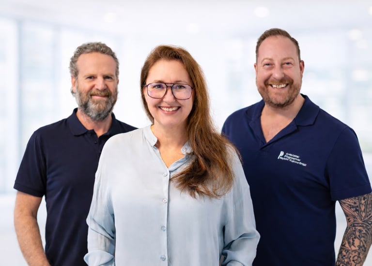 Smiling team of professional healthcare workers in uniform posing for a corporate group portrait.