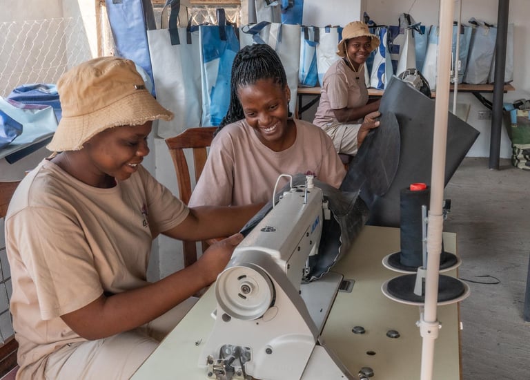 community woman at work sewing bags