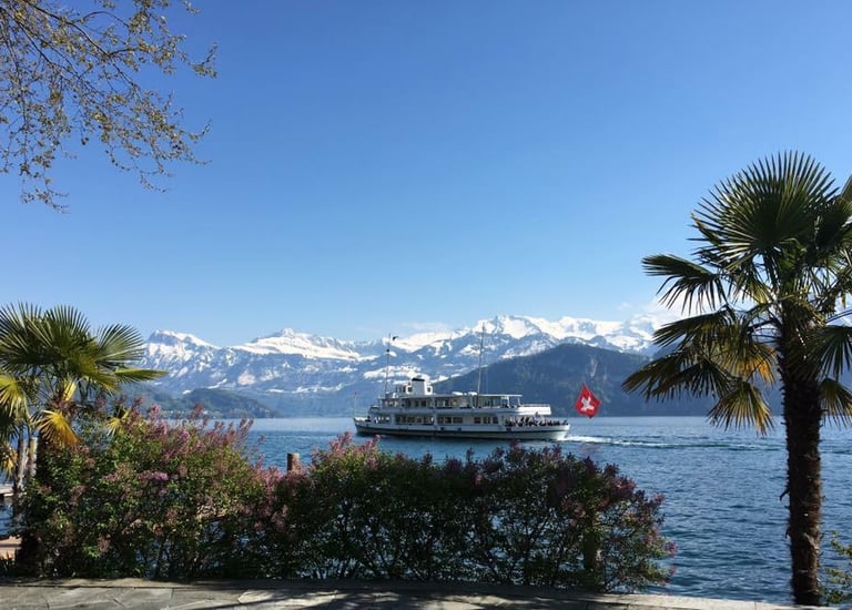 a boat on the water with mountains in the background
