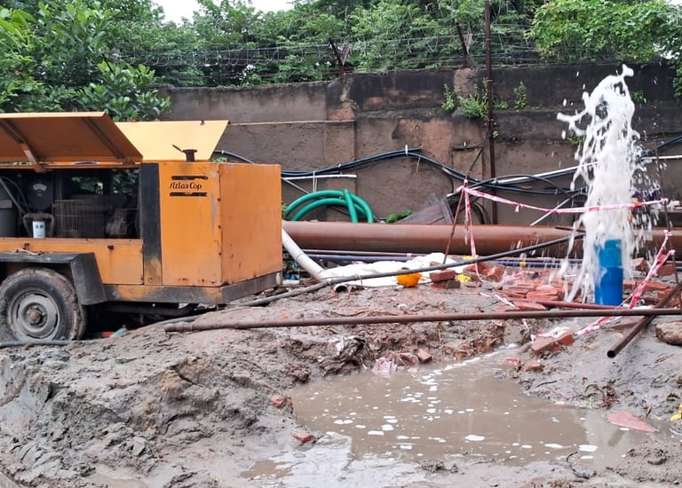 a truck with a hose attached to a pipe